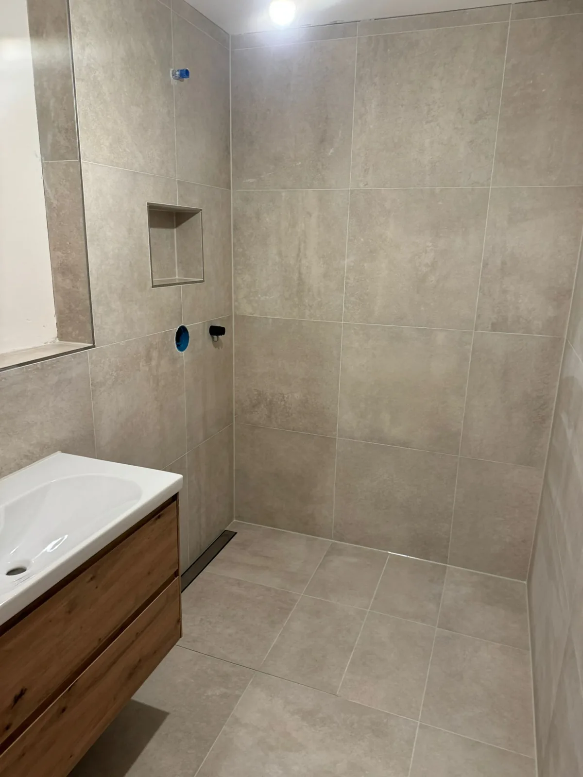 Walk-in shower with linear drain in the loft ensuite