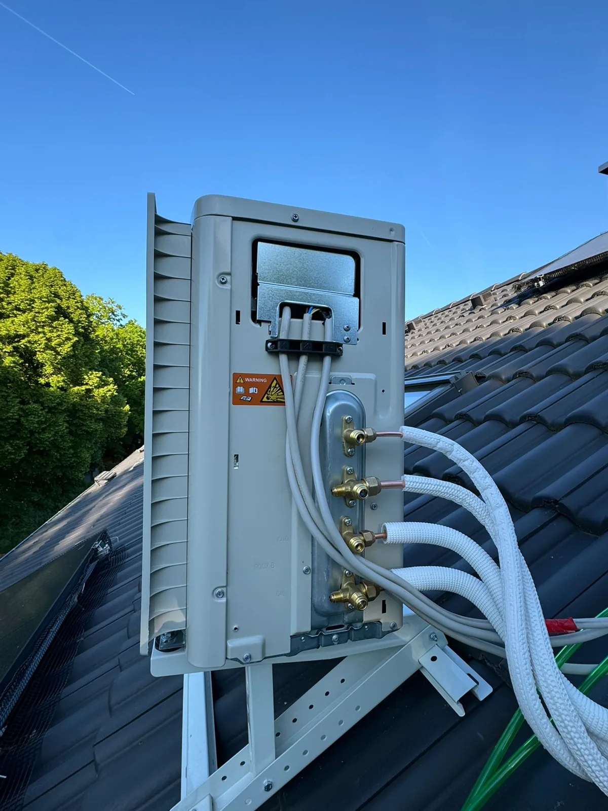 Outdoor heat-pump condenser with lagged line-set on a roof