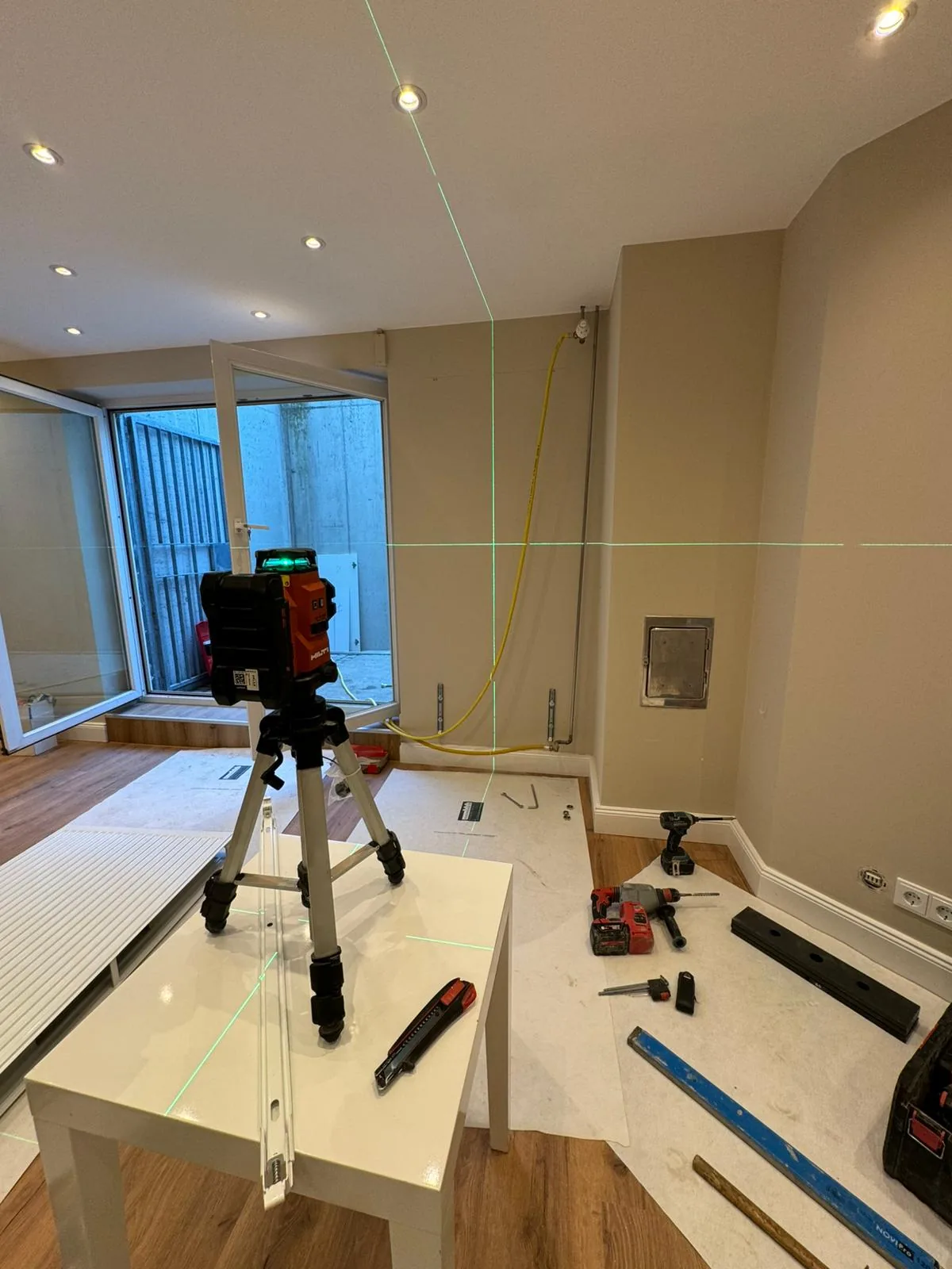 Interior fit-out set out with a green laser level