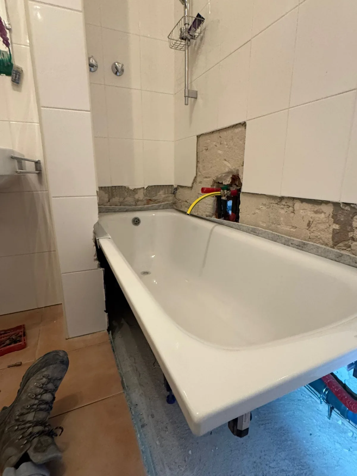 Bathtub re-pipe with exposed pipework during a repair